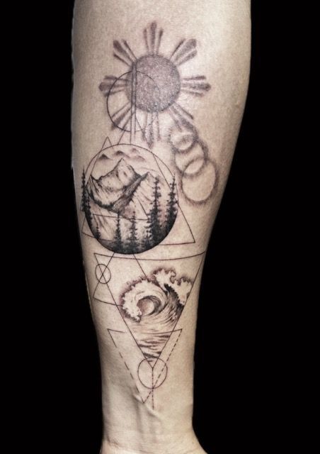 Tattoo on arm: Sun, mountain scene in circle, ocean wave, geometric shapes, all in black ink.