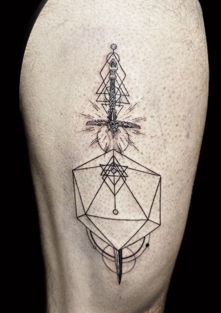 Tattoo of a geometric sword with intricate lines and shapes on a person's thigh.