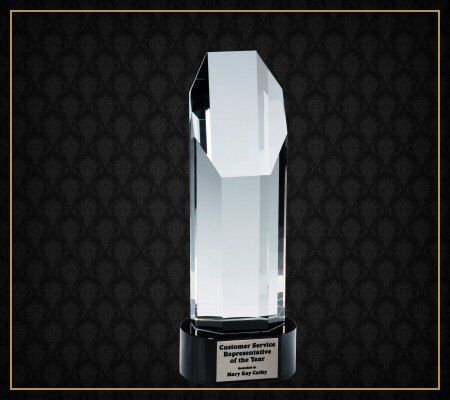 A clear glass trophy that says diamond service on it