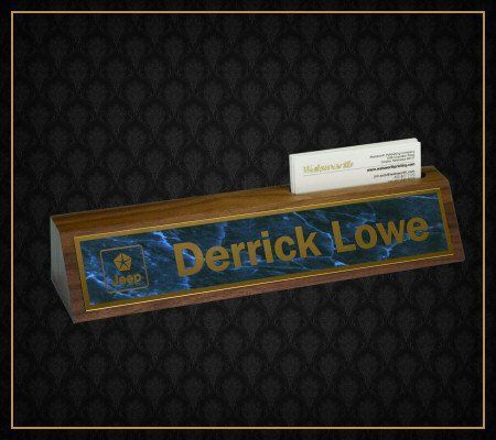 A wooden name plate with the name derrick lowe on it