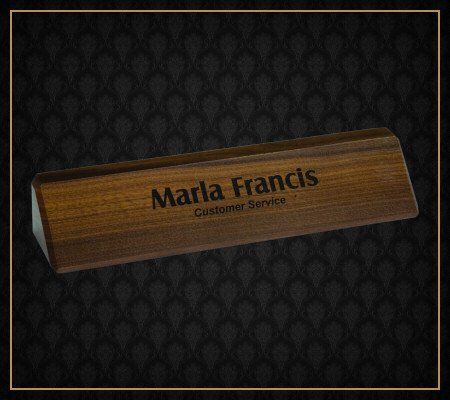 A wooden name plate with marta francis written on it