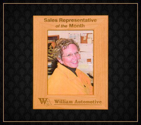A framed picture of a sales representative of the month
