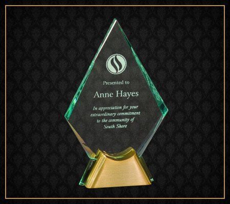 A diamond shaped glass plaque presented to anne hayes