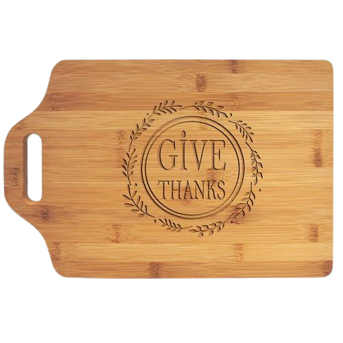 A bamboo cutting board with the words `` give thanks '' engraved on it.