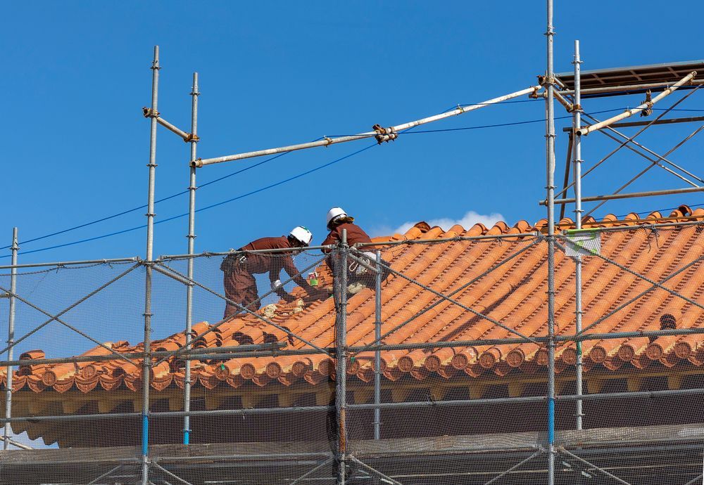 Two Construction Workers on a Rooftop With Scaffolding, Repairing Tile — D & E Milner Plumbing In The Palms, QLD