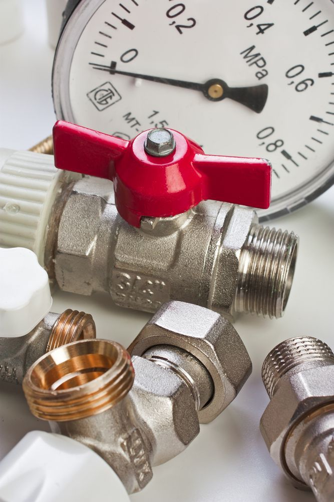 Close-up of Plumbing Components: Red Valve, Pressure Gauge, and Fittings — D & E Milner Plumbing In The Palms, QLD