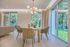 A dining room with a table and chairs and a chandelier.