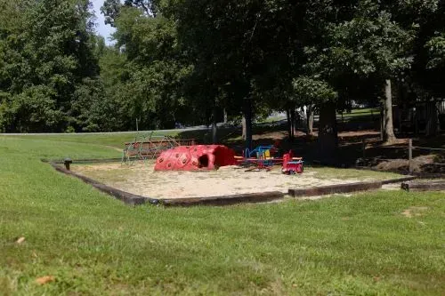 There is a sandbox in the middle of the park.