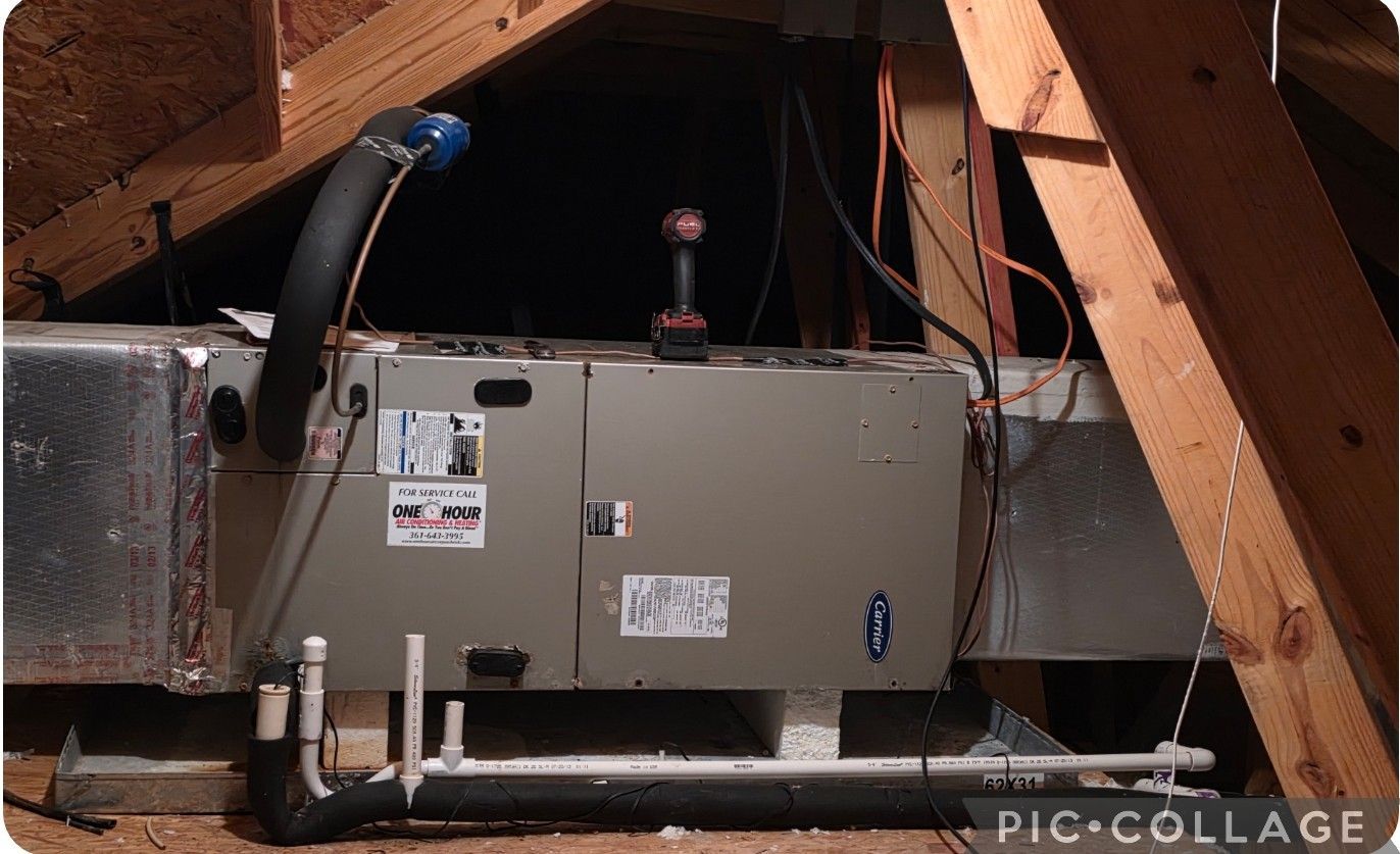 HVAC unit in an attic; gray metal box, ducts, insulation, and wooden rafters.