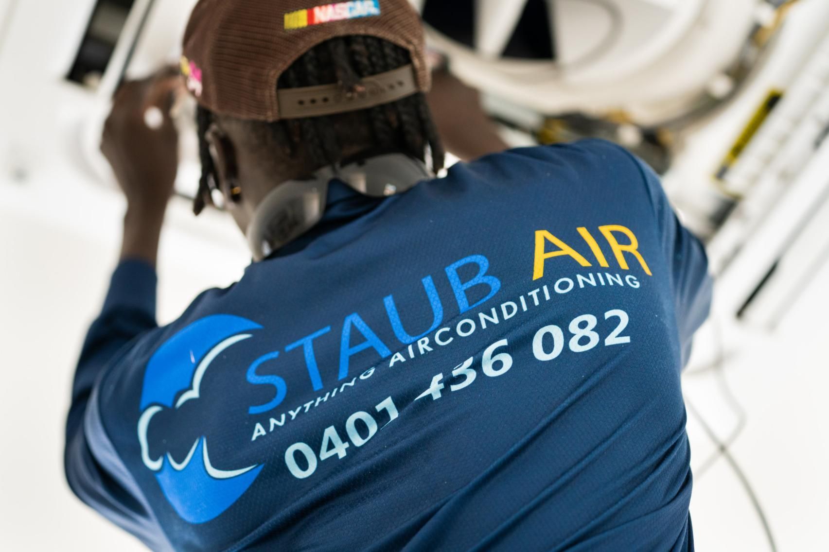 A Man Wearing a Blue Shirt that Says Staub Air — Staub Air in Garbutt, QLD