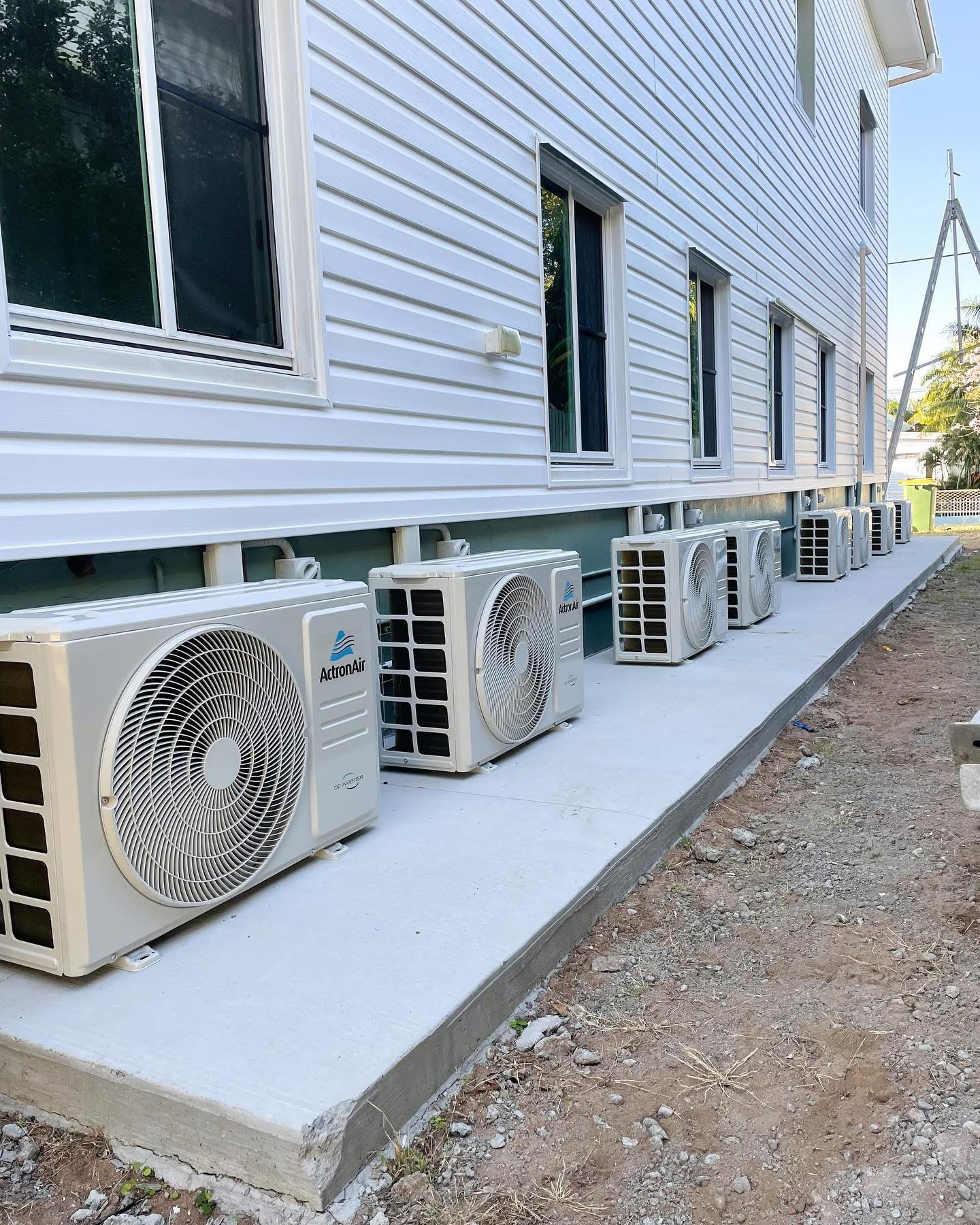 A Row of Air Conditioners Are Sitting Outside of A Building — Staub Air in Garbutt, QLD