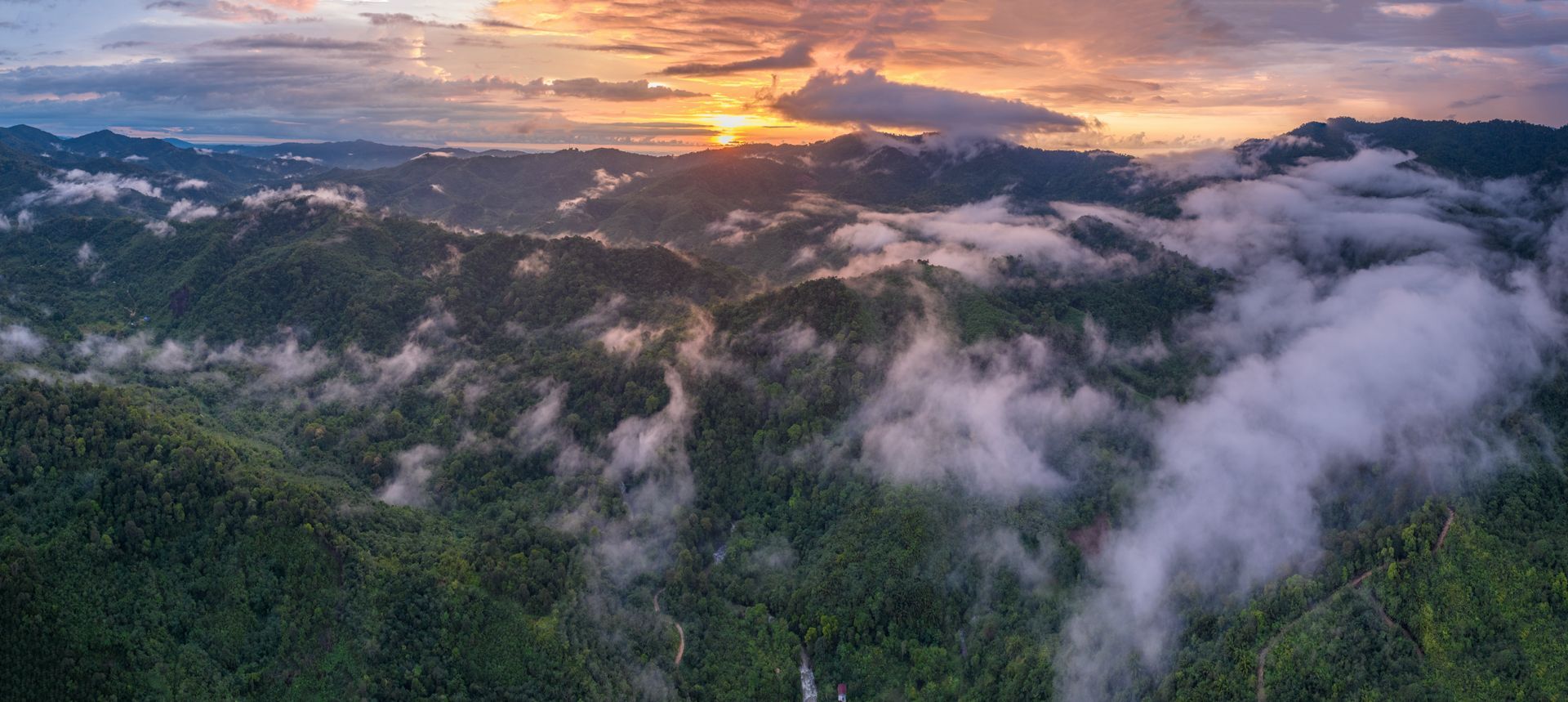 Sunset over the mountains of Borneo in Malaysia, photographed on assignment for Synchronicity Earth