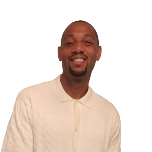 Man with a goatee smiling, wearing a cream-colored collared shirt.