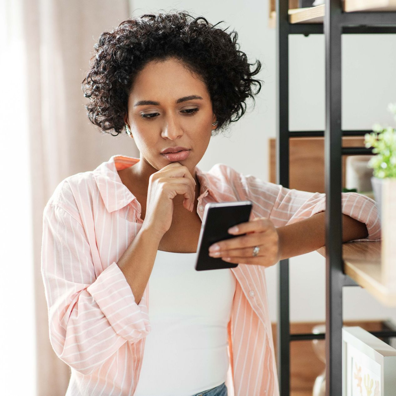 Couple in counseling session, woman holding head, man talking, therapist holding clipboard.