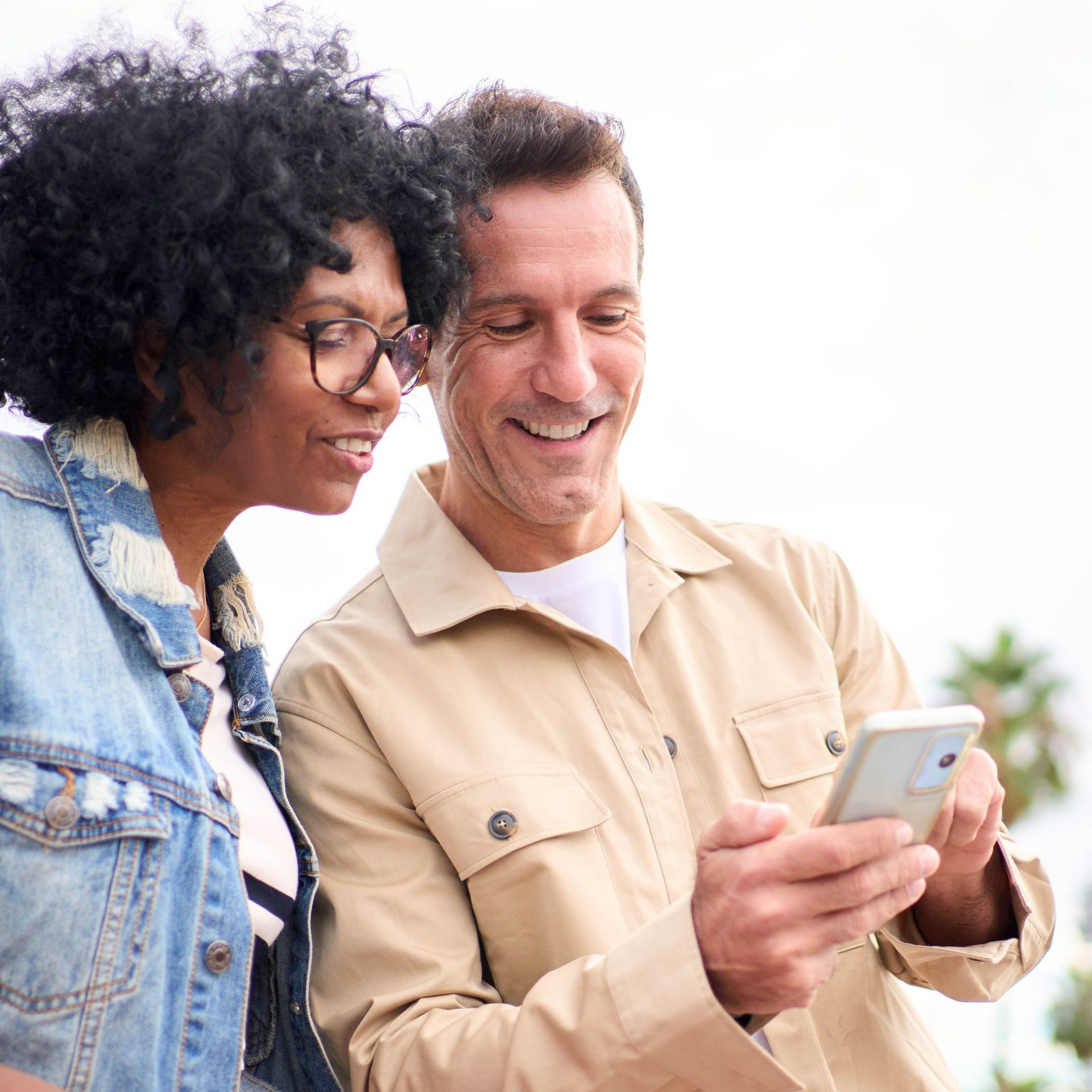 Therapist takes notes while patient sits on a sofa, hands clasped.