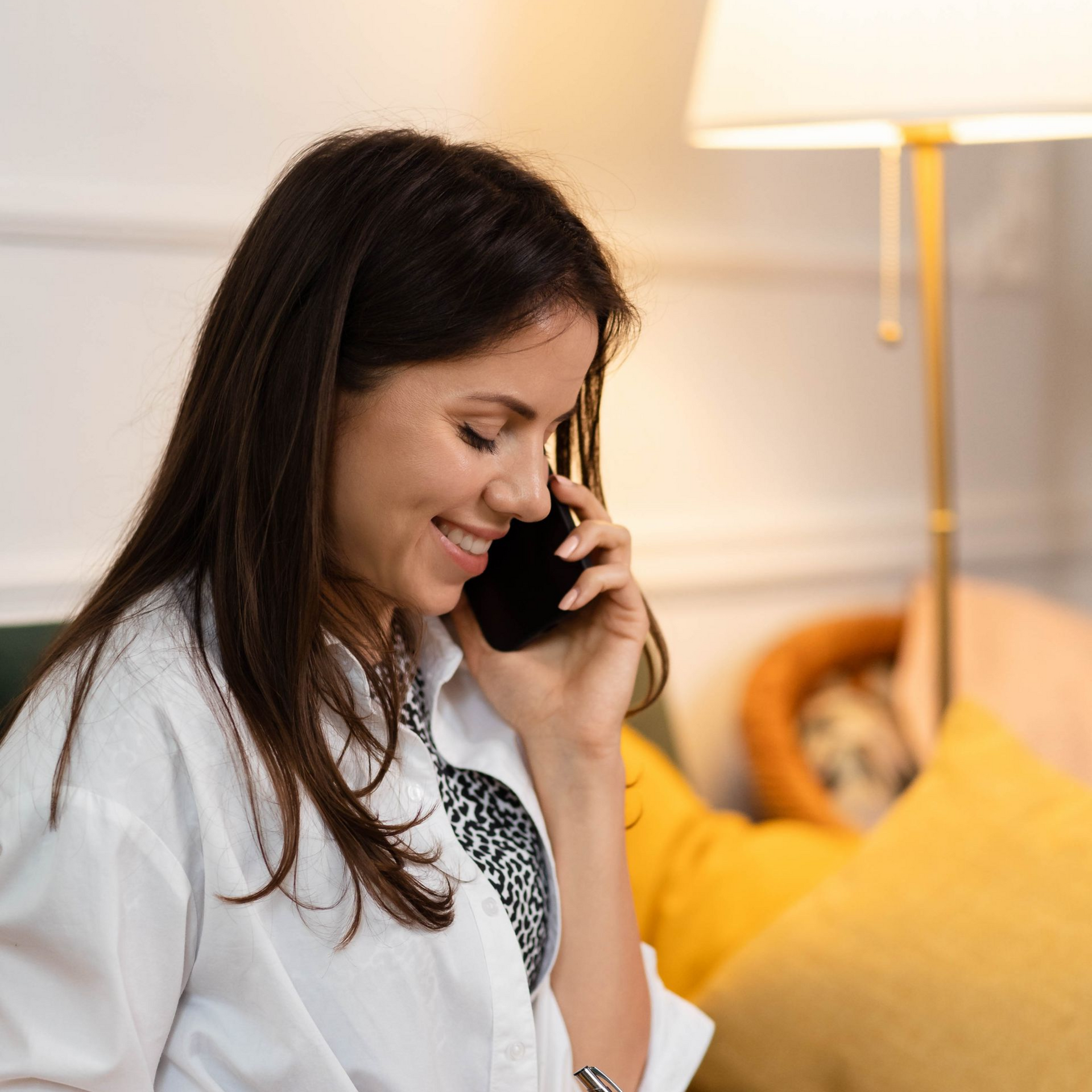 Hands of a couple with wedding rings on an open book next to a bouquet of roses.