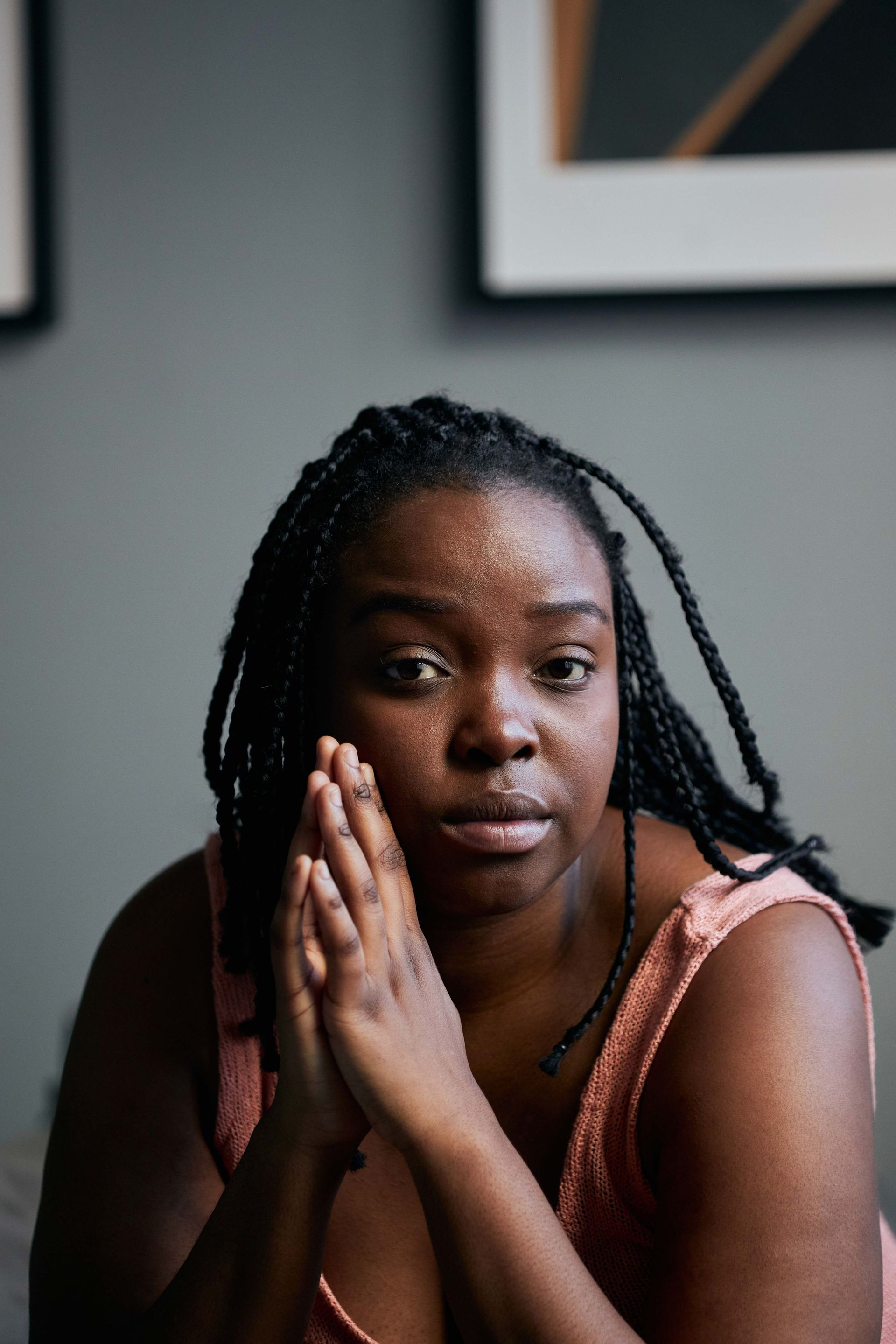 Couple smiling at a cafe, enjoying pastries. Man wears leather jacket, woman has curly hair, both at a table.