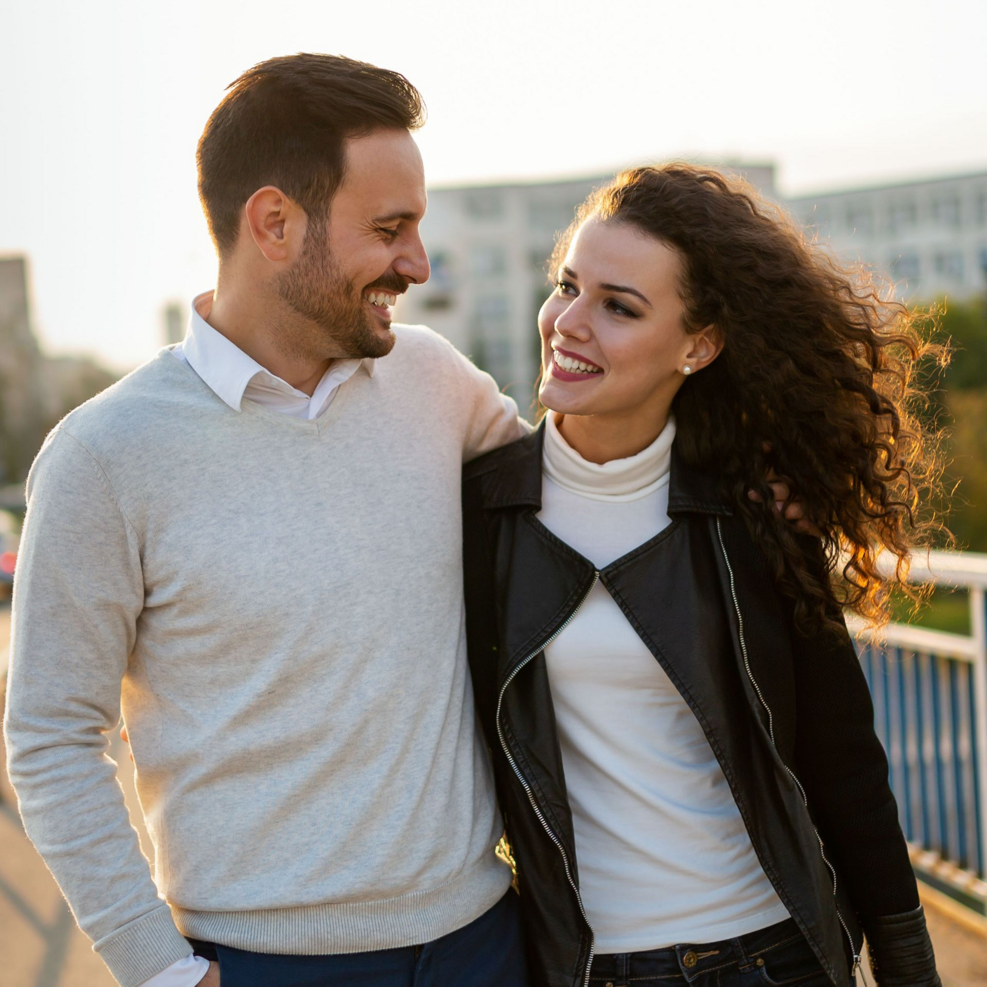 People in a group therapy session; two women embrace while others clap.