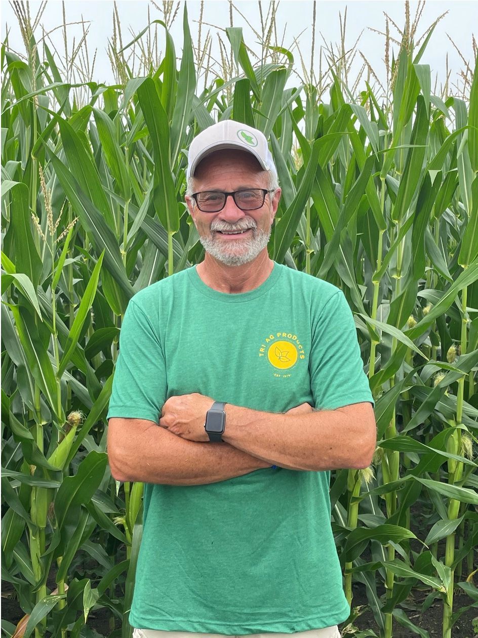 Chuck Grau happy in front of his field.