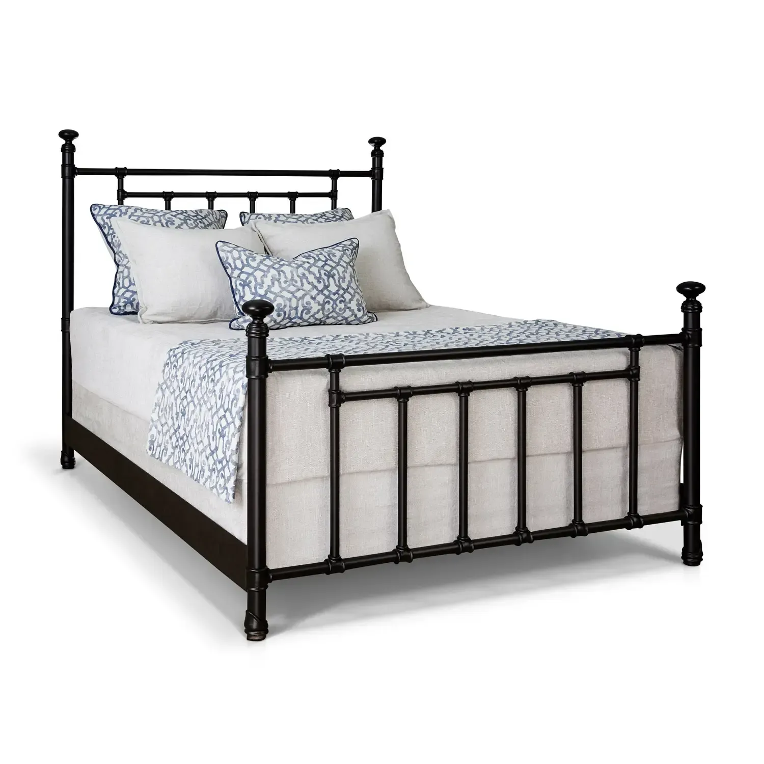 A black metal bed frame with white sheets and pillows