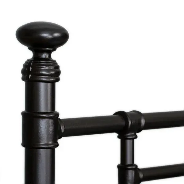 A close up of a black metal bed frame on a white background.
