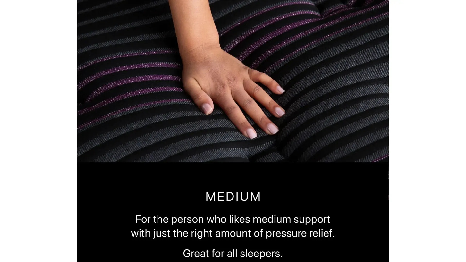 A woman 's hand rests on a black striped fabric