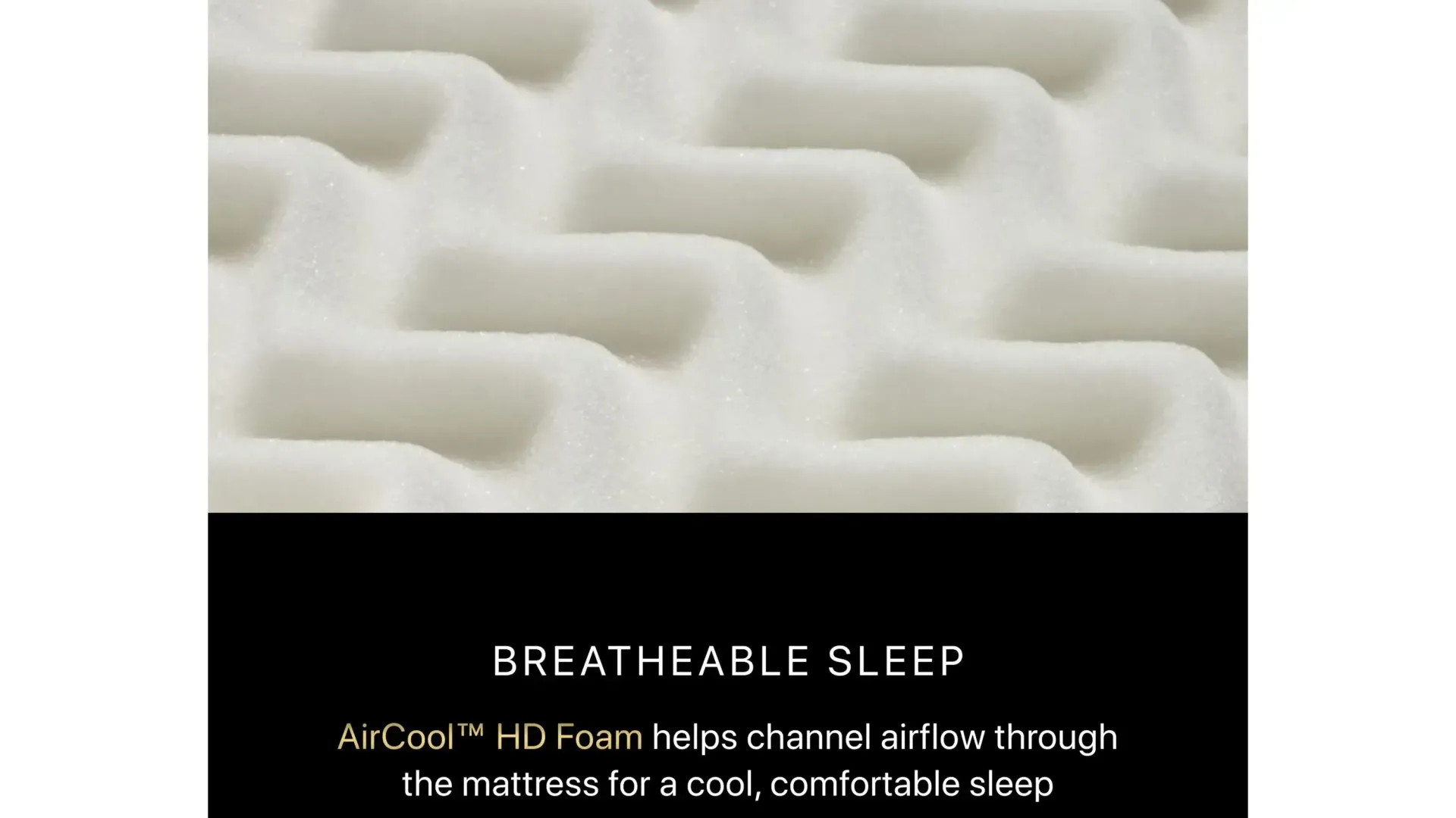 A close up of a white foam mattress with a black background