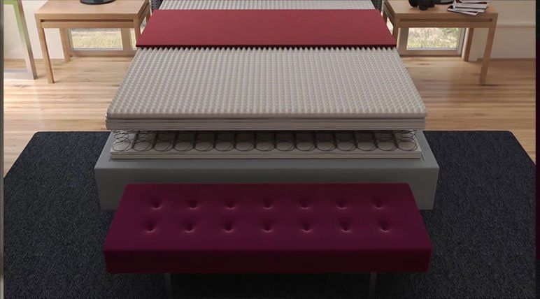 A mattress is being cut in half in a bedroom.