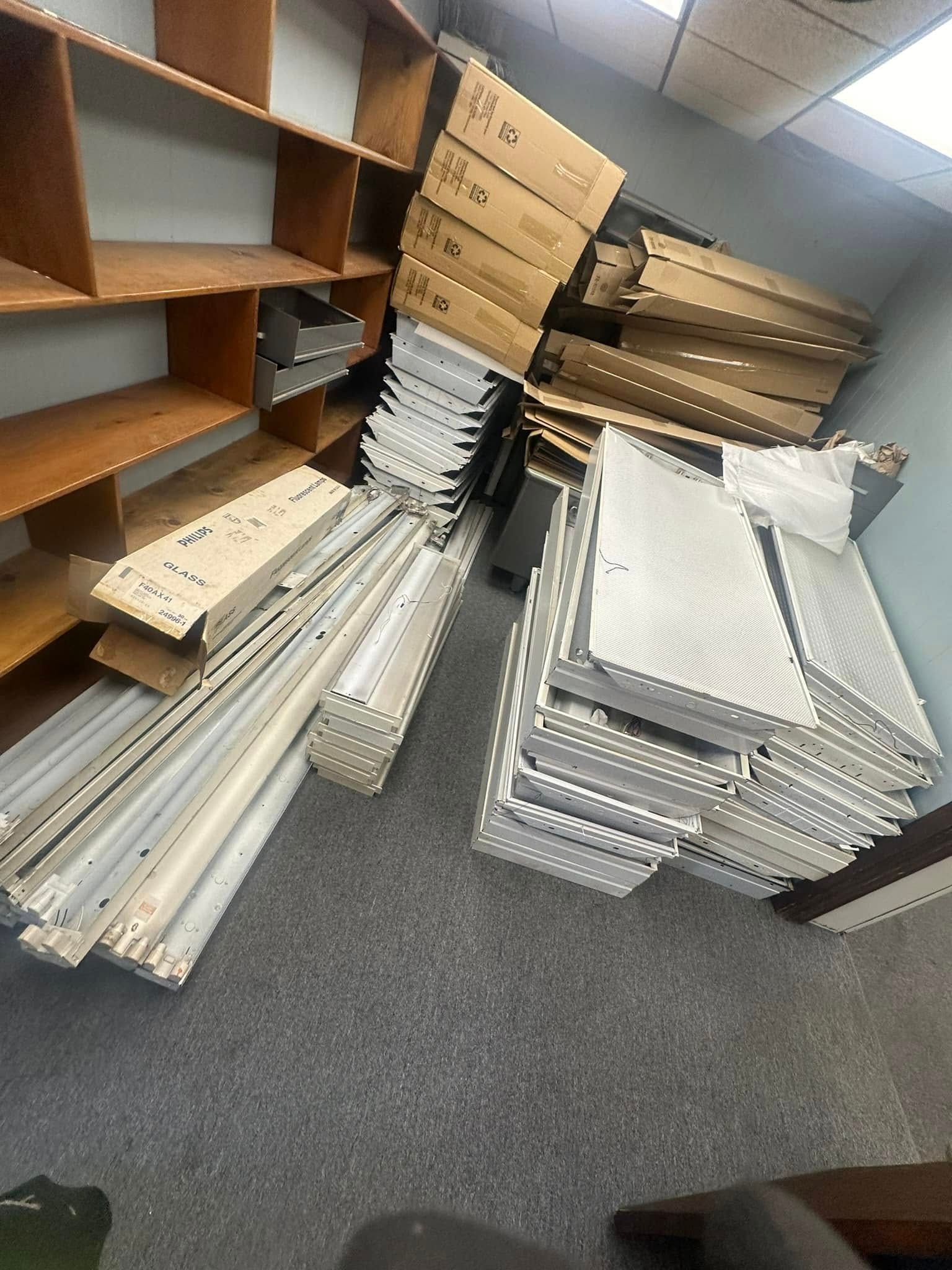 Shelves and boxes collapsed on floor. White and brown items scattered in a cluttered room.