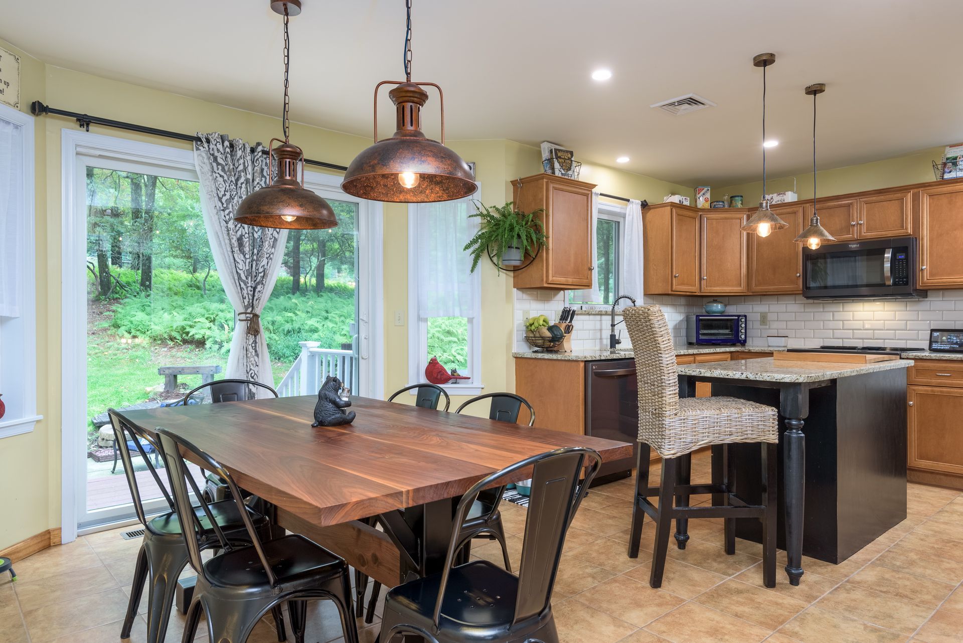 A kitchen with a dining table and chairs in it.