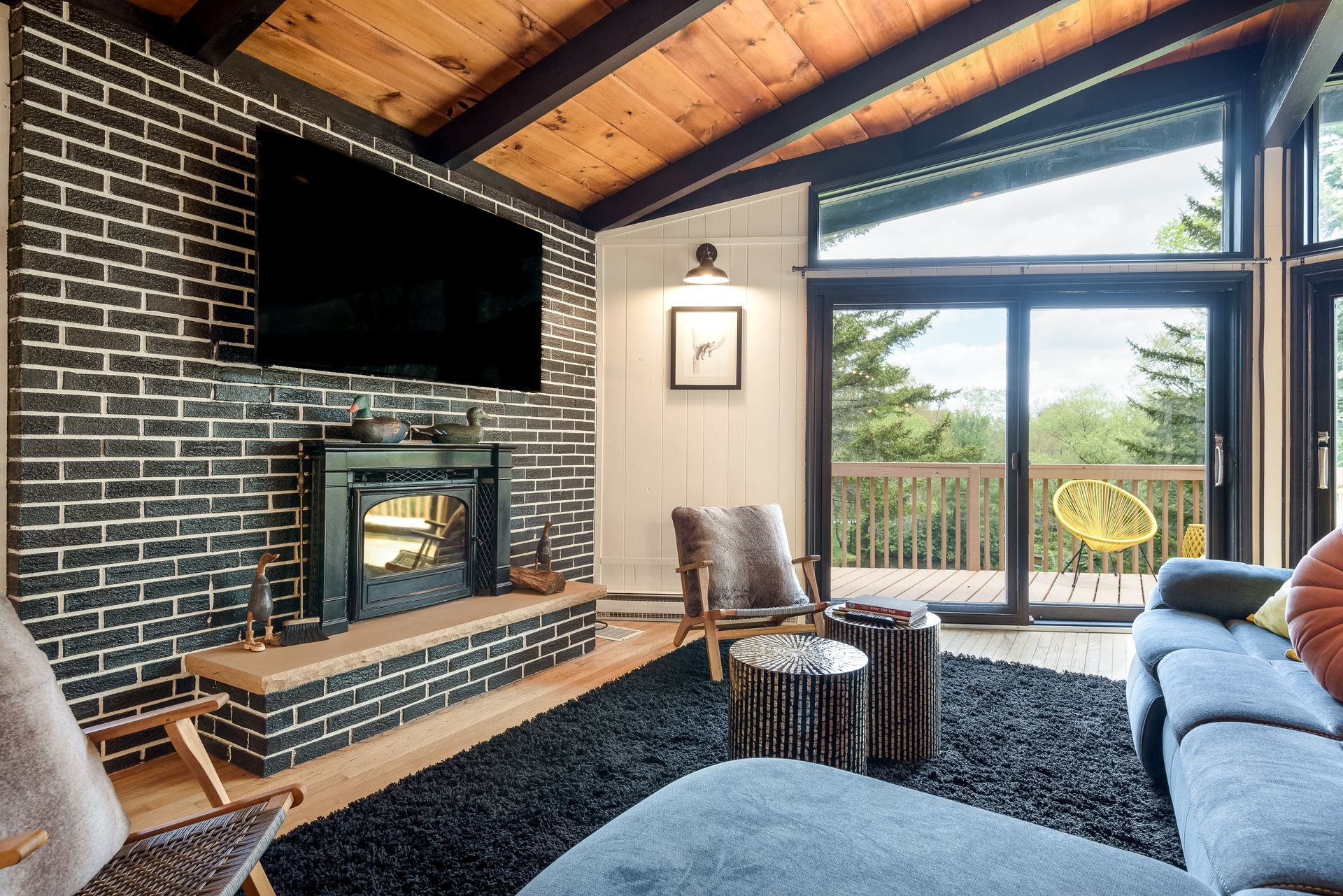 A living room with a fireplace and a flat screen tv.