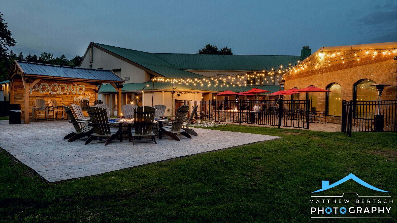 A large building with a lot of chairs and tables in front of it.
