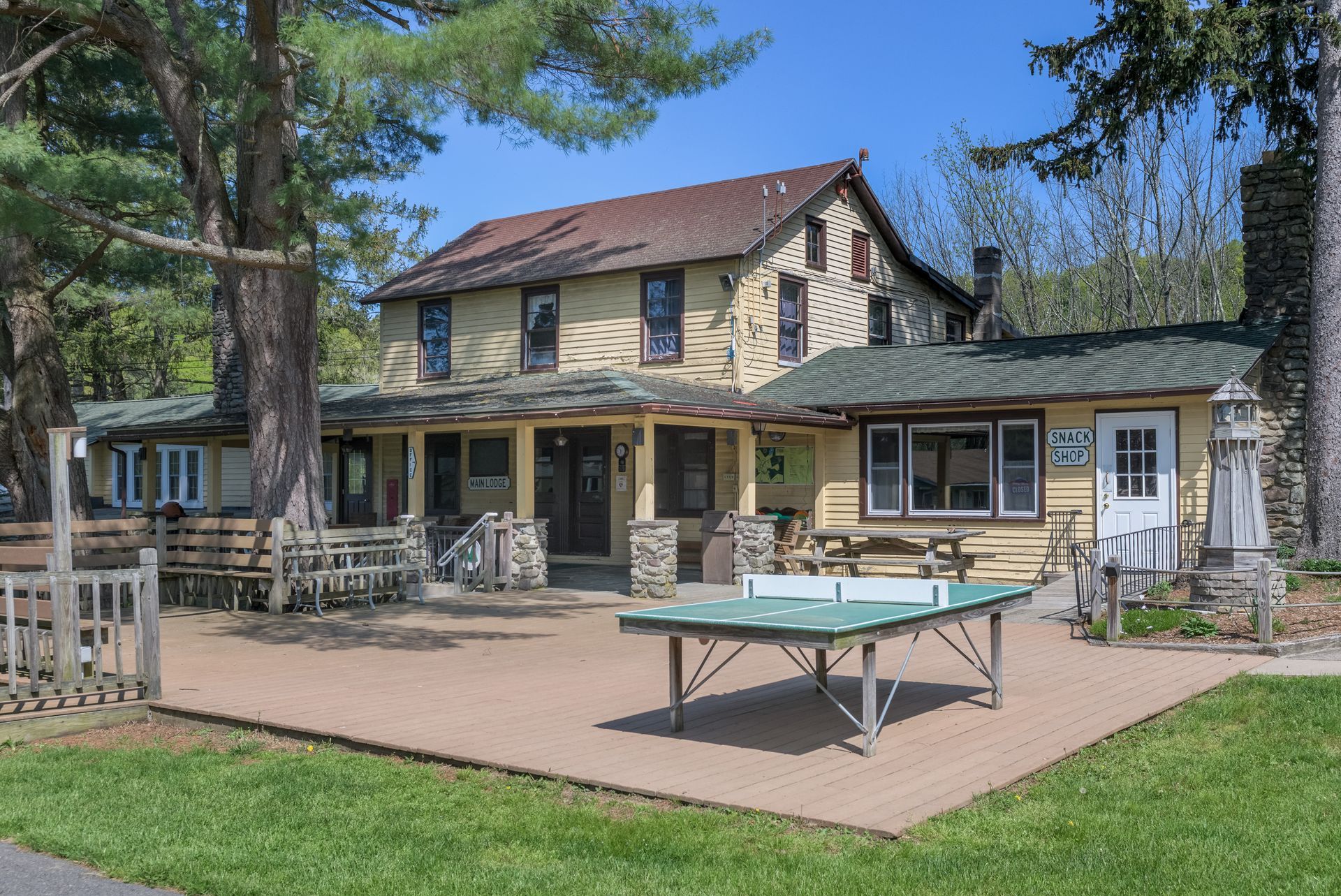 A large house with a ping pong table in front of it.
