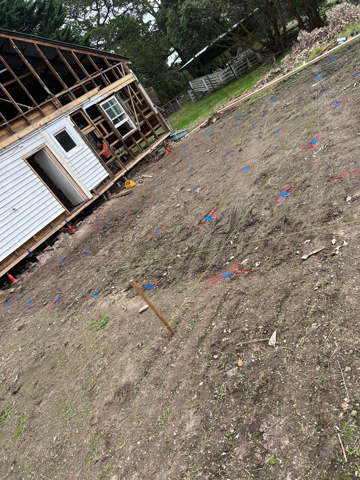 A white and orange building with balconies and a blue sky in the background