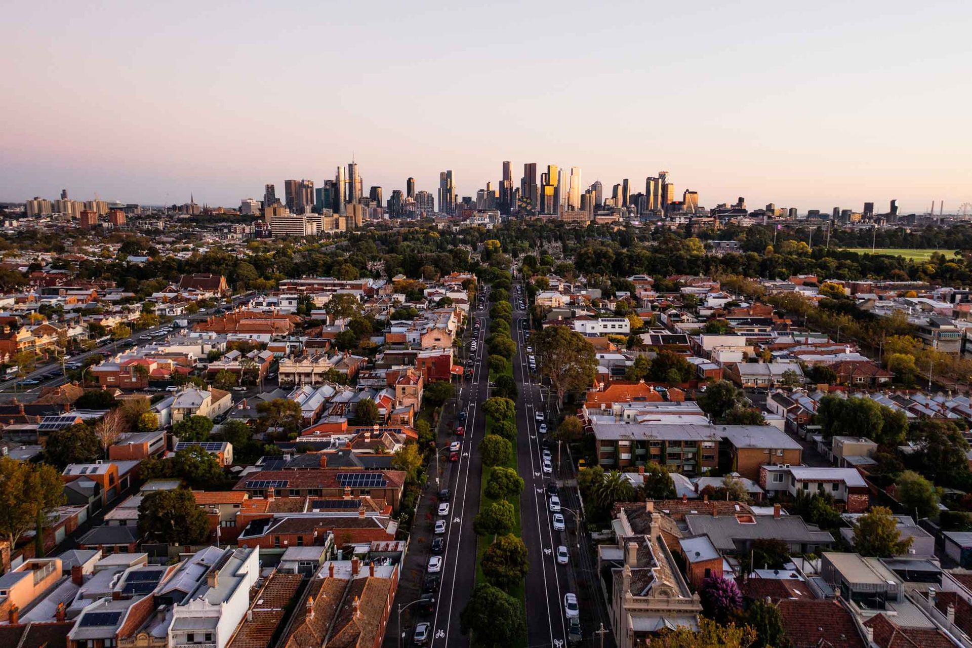 An aerial view of a city with a skyline in the background.