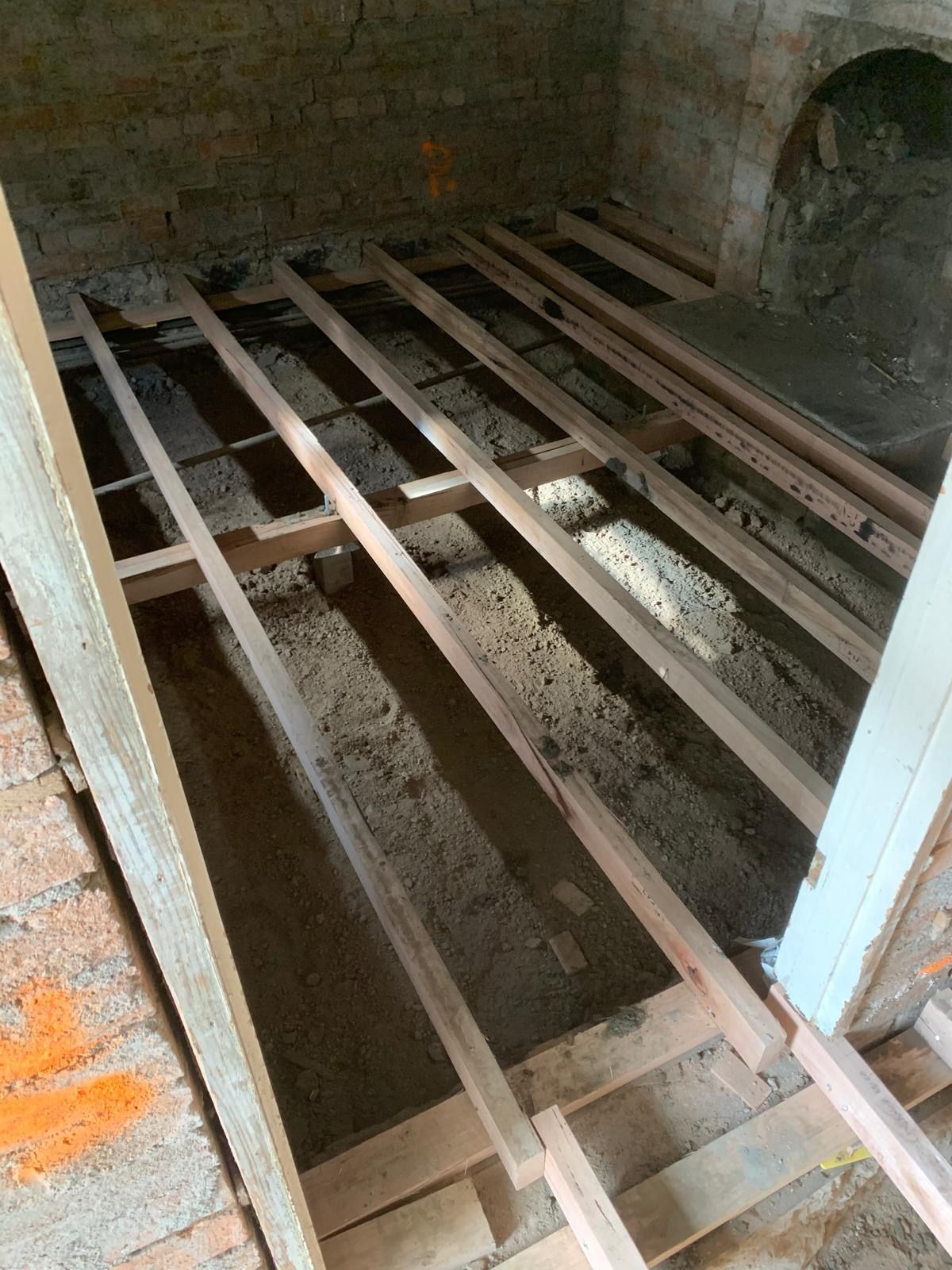 A wooden floor is being built in a room.