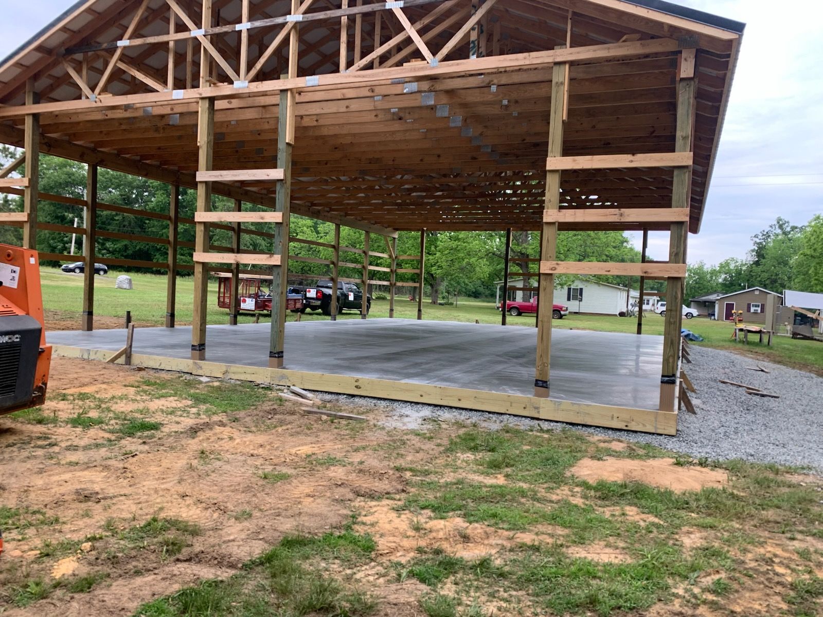 An aerial view of a dirt field being built in front of a house.