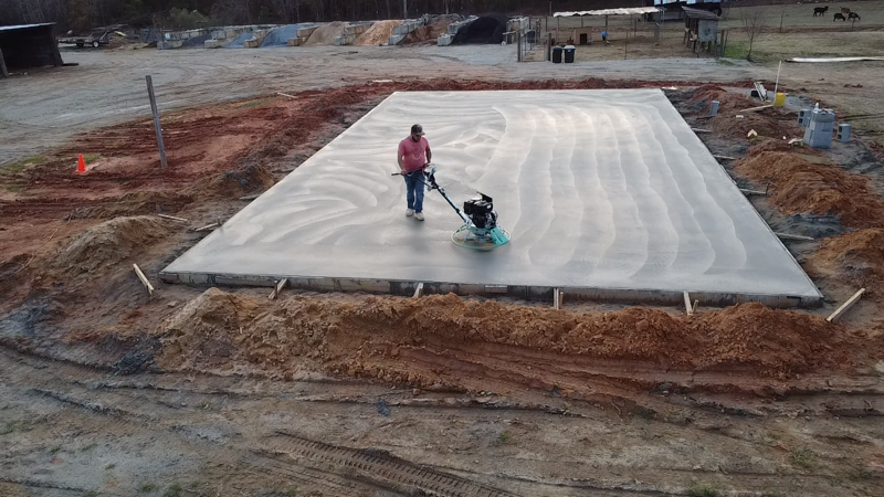 A swimming pool is being built in the backyard of a house.