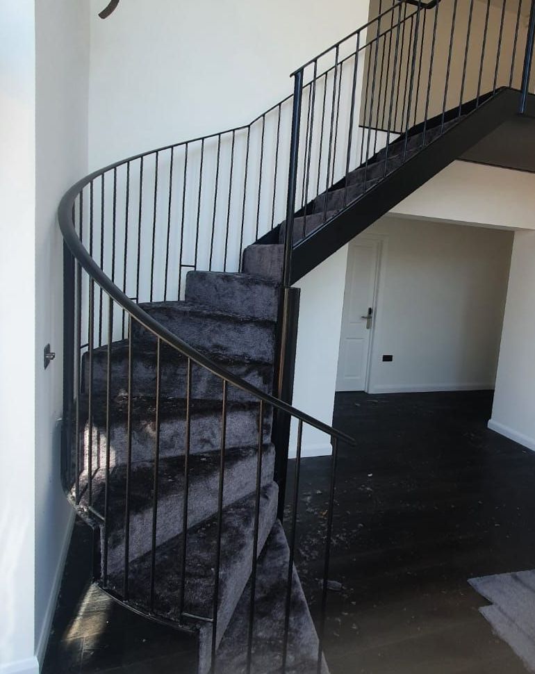 a black spiral staircase with a black railing