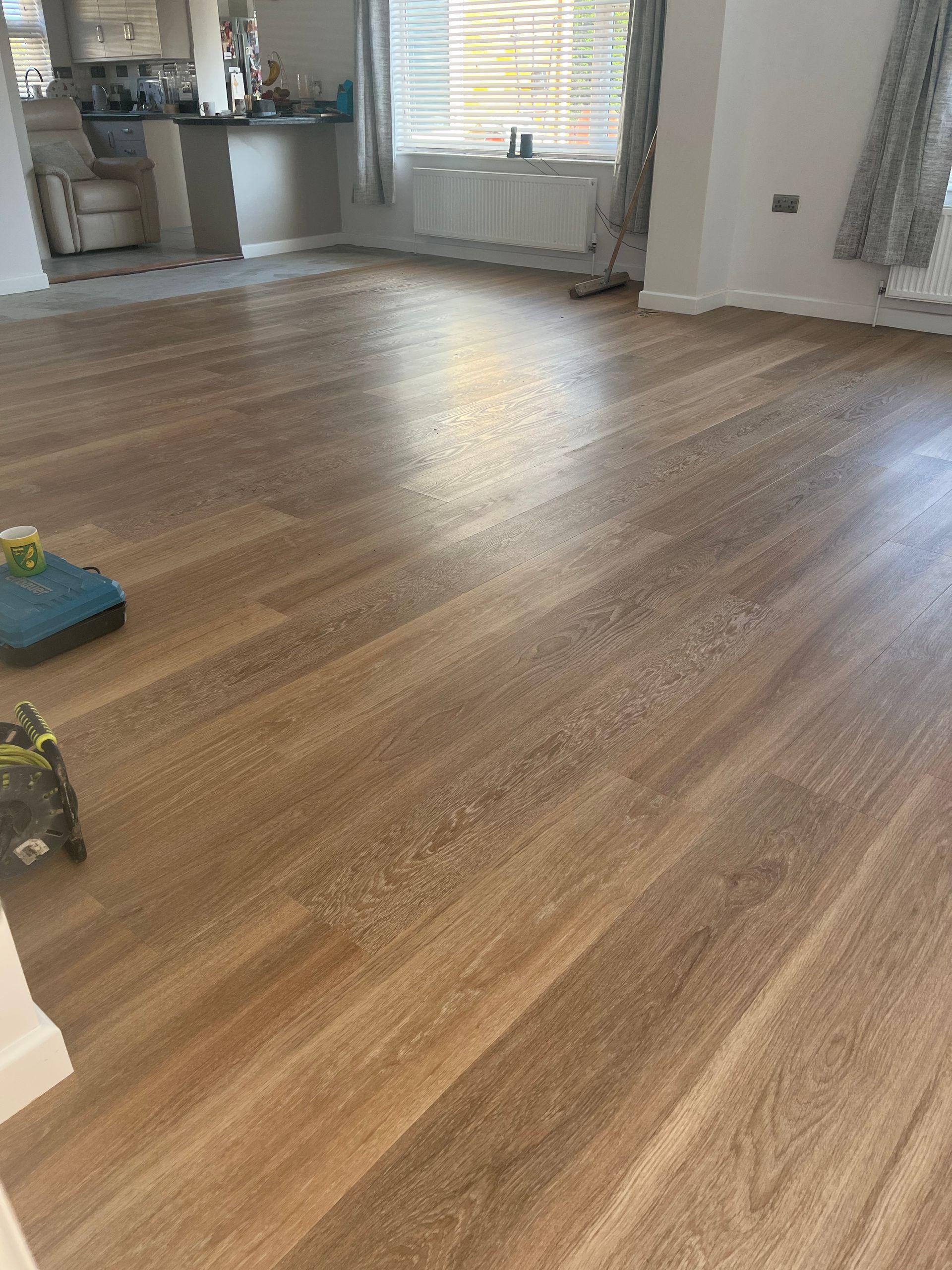 a vacuum cleaner sits on a wooden floor in a living room