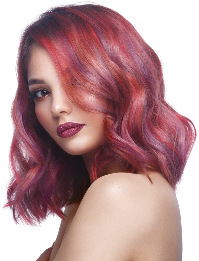 Portrait of a woman with wavy pink-red hair and dark lipstick against a white background