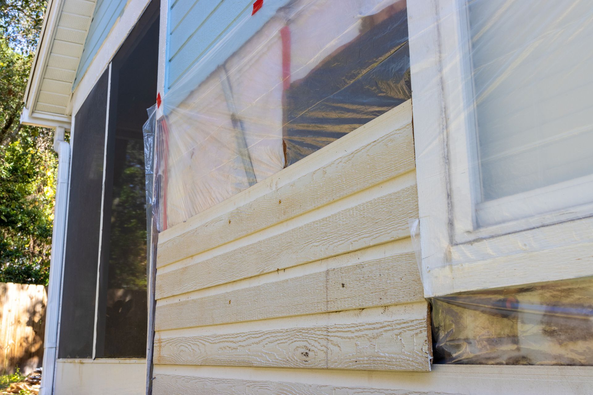 The Side of A House with A Window Covered in Plastic | Dickinson, ND | Unleashed Contracting