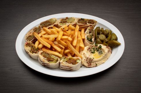 Arabi Falafel A plate of food with french fries and hummus on a table.