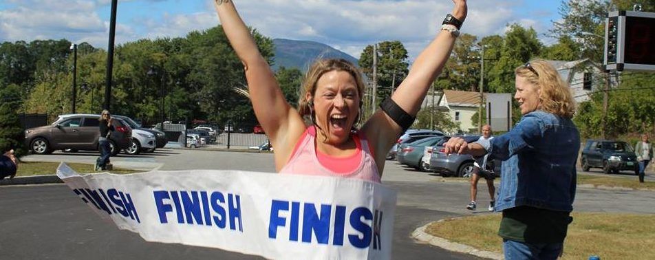 A woman is holding a banner that says finish finish