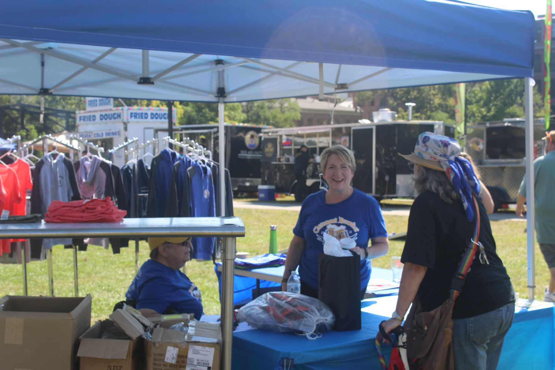 A woman in a blue shirt is talking to another woman