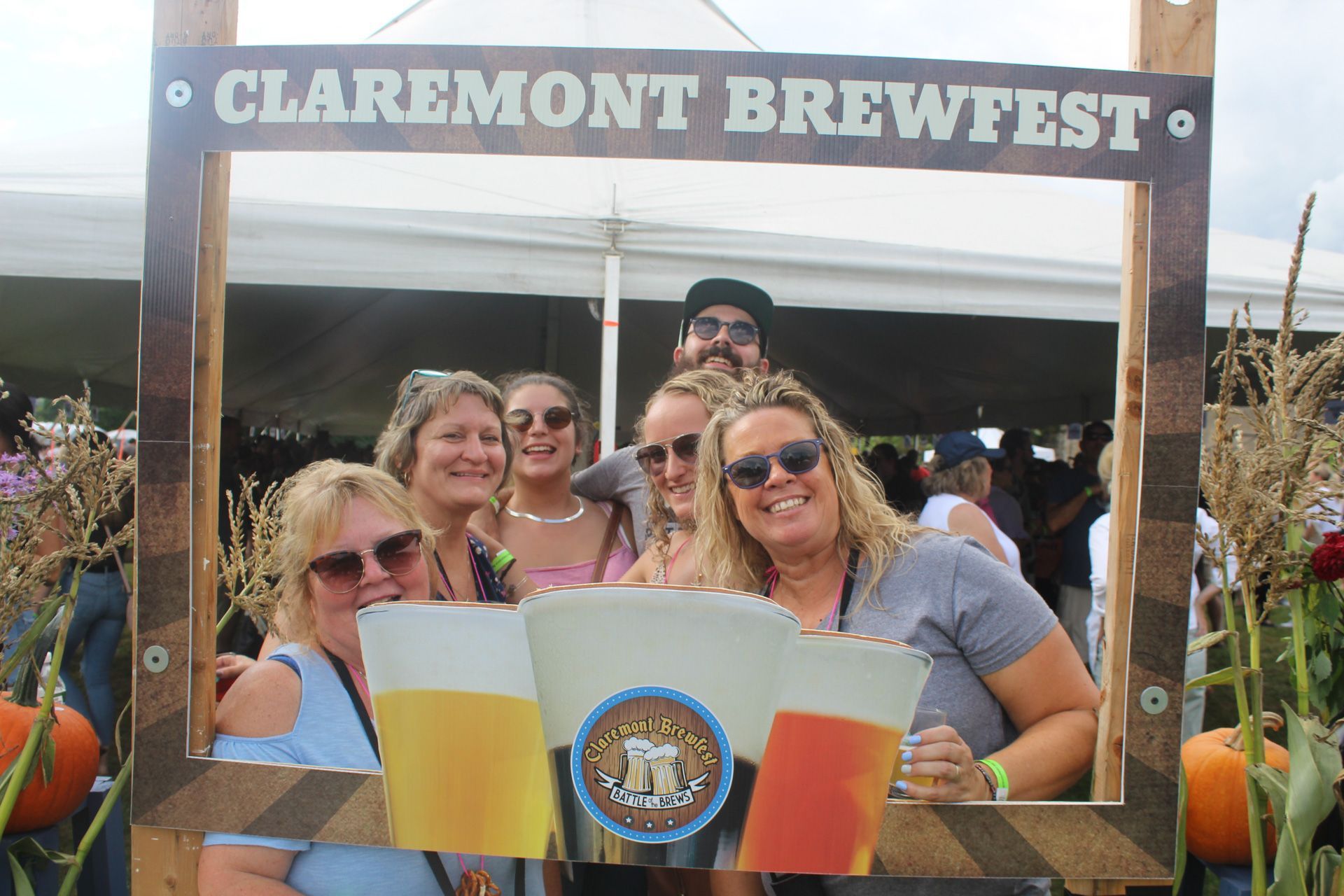 A group of people are posing for a picture at a brewfest.