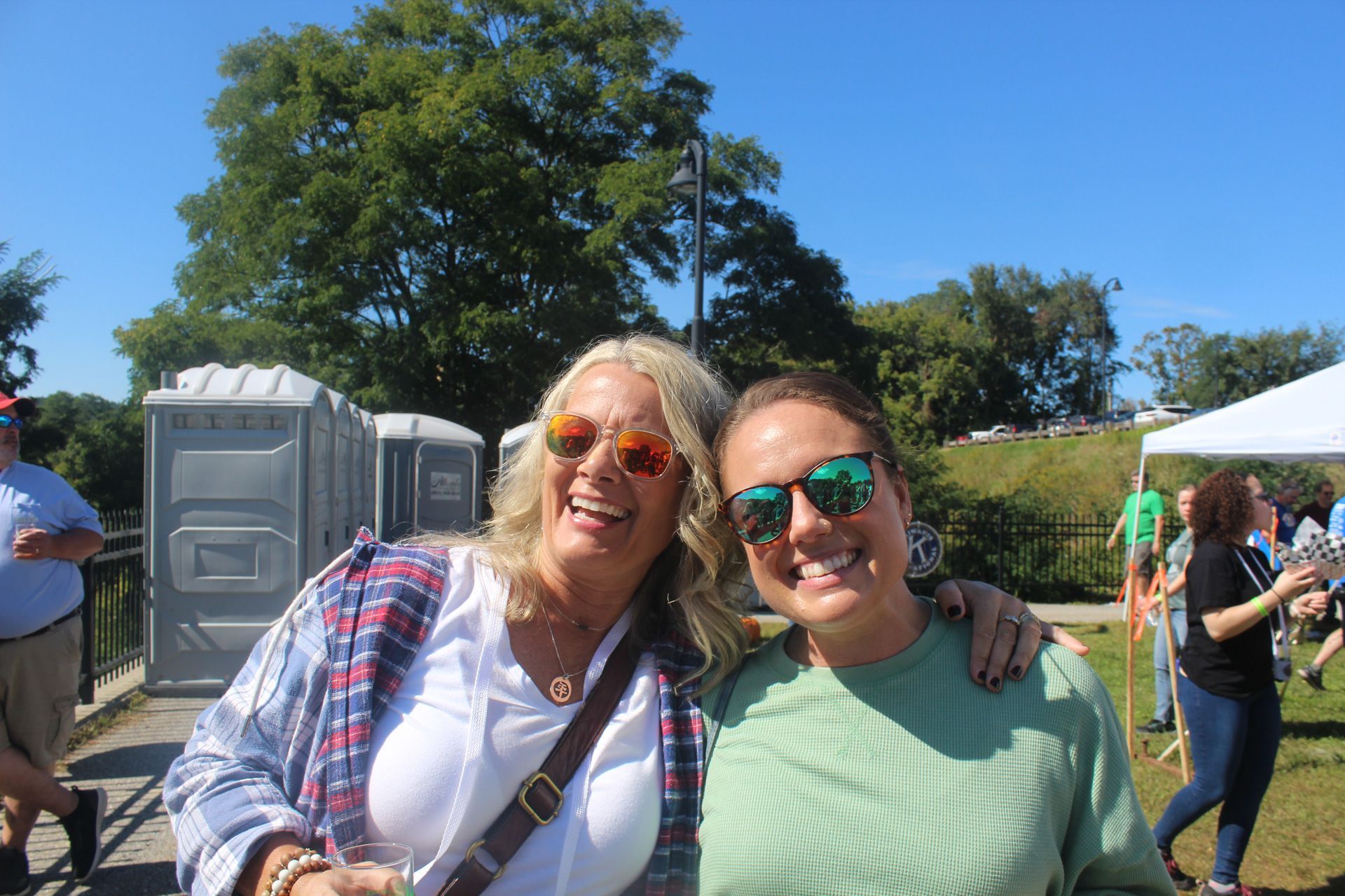 Two women wearing sunglasses are posing for a picture.