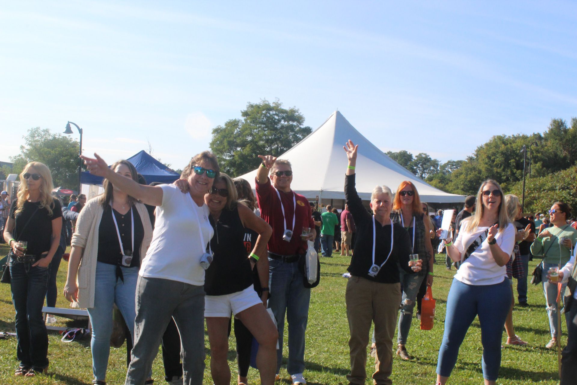 A group of people are posing for a picture in a field.