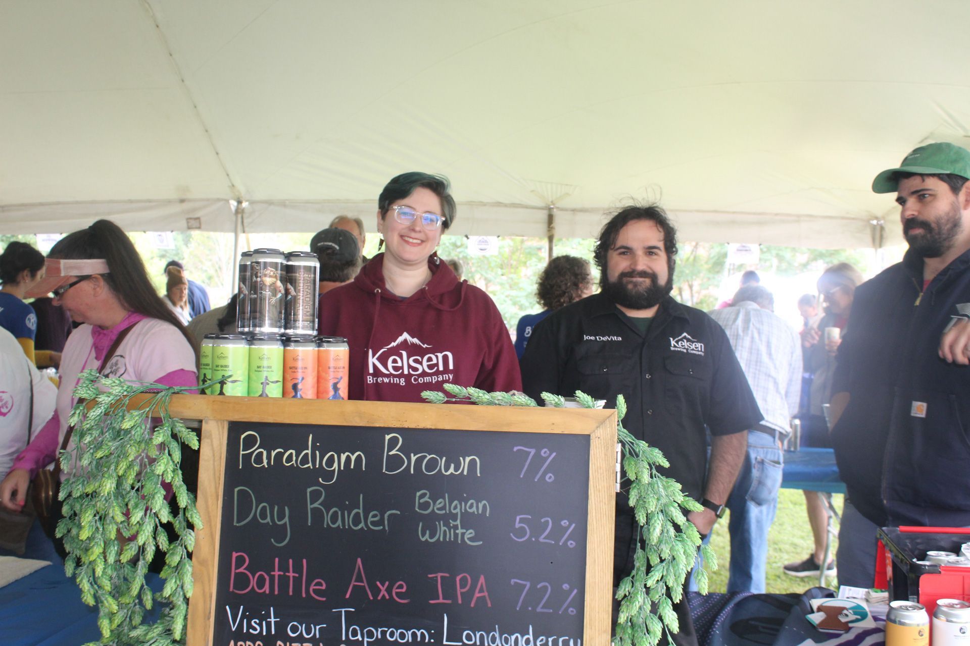 A group of people standing around a sign that says paradox brown 7 %