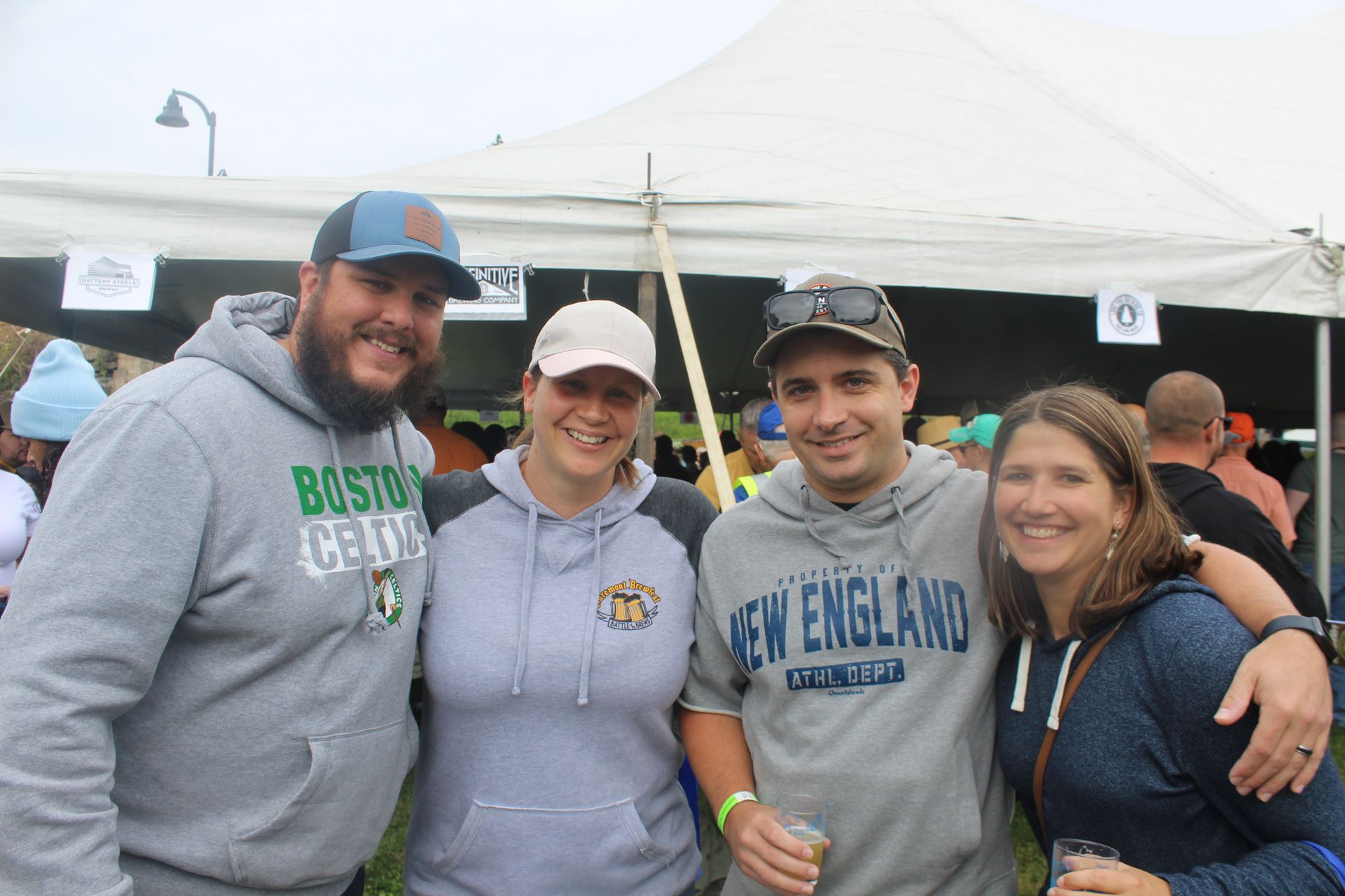 A group of people posing for a picture in front of a tent.